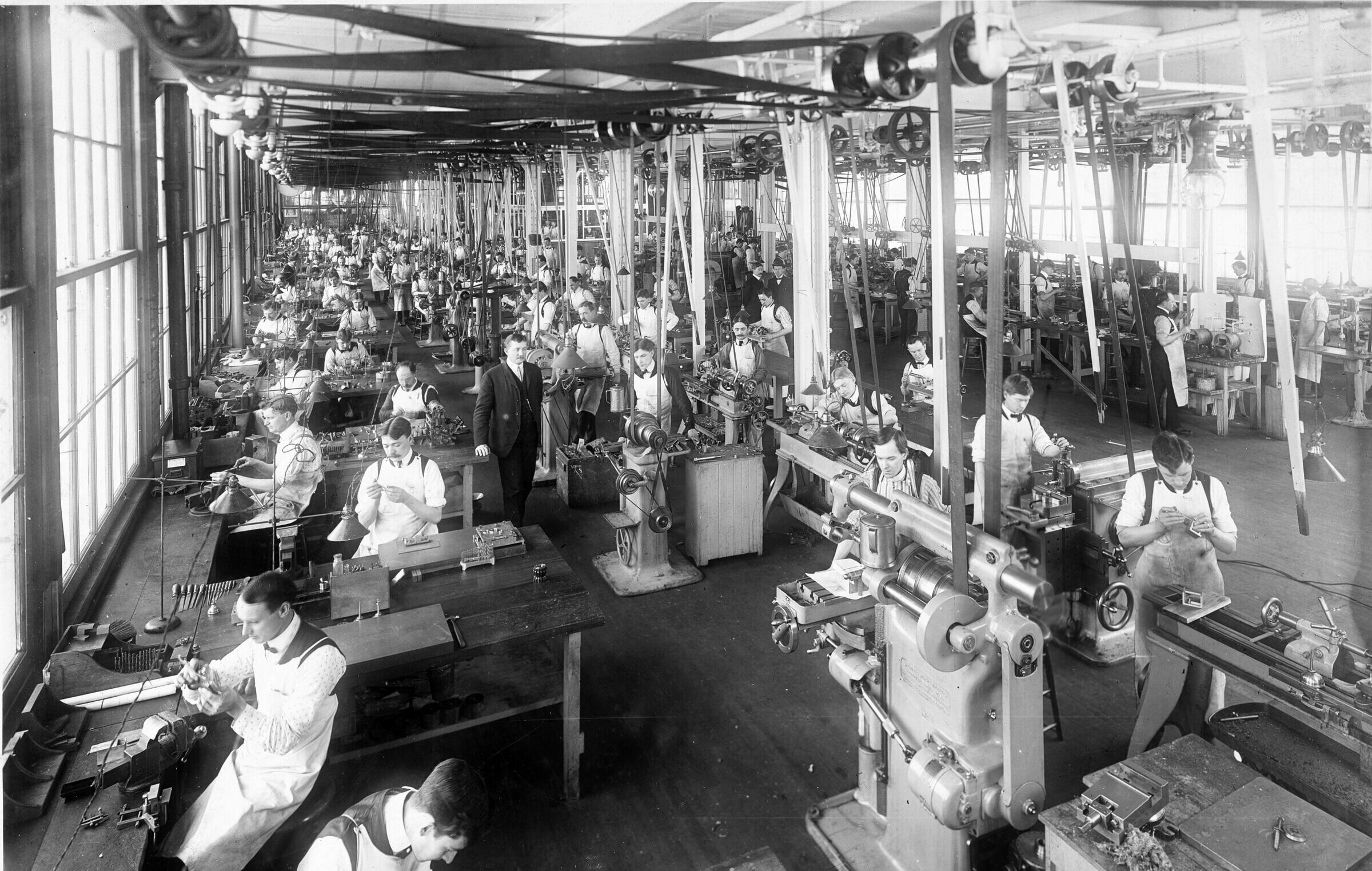 A factory tool room in 1904, with a belt running down to every machine from shafts in the ceiling